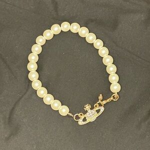 Add-on to any bundle $5. Pearl Saturn Bracelet. 8.5 inches in length. Brand new.